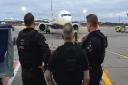 Police officers arrested a man as he stepped off a flight at Stansted Airport