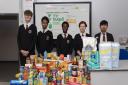 Youngsters from Barking Abbey with donated food. Students at the school have raised ?500 for The Trussell Trust charity. Picture: Stuart Cohen