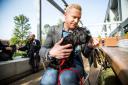 Iwan Thomas takes part in an experiment in a bid to find out if interacting with dogs can reduce heart rate and stress levels. Picture: Sportsbeat/Roberto Payne