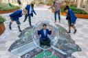 3D street artist Joe Hill and St Edward's Primary pupils unveil the illusion painting in Upton Gardens.