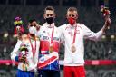 Great Britain's Jonathan Broom-Edwards celebrates with his gold medal after winning the Men's High Jump - T64 final alongside second placed India's Kumar Praveen (left) with his silver medal and third placed Poland's Maciej Lepiato with his bronze medal