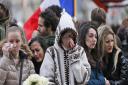 People pay respect to the victims in front of the Carillon Restaurant in Paris where terrorists attacked on Friday. Picture: Frank Augstein/PA Wire