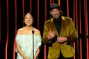Greta Lee, left, and Troy Kotsur present the award for outstanding performance by a male actor in a television movie or limited series during the 30th annual Screen Actors Guild Awards (AP Photo/Chris Pizzello)