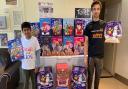 Neo Jain Naha, nine, hands over more than 400 advent calendars to AAA's James Corcoran