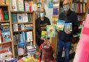John Newham from the Newham Bookshop hands over a donation of books to Paula Blake.