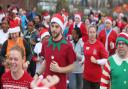 Participants join the Festive Run dressed as Santas at the Queen Elizabeth Olympic Park, Stratford.