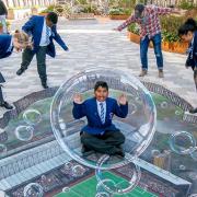 3D street artist Joe Hill and St Edward's Primary pupils unveil the illusion painting in Upton Gardens.