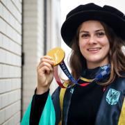 BMX star and honorary doctorate of sport recipient Bethany Shriever with her Tokyo 2020 gold medal.