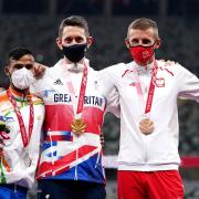 Great Britain's Jonathan Broom-Edwards celebrates with his gold medal after winning the Men's High Jump - T64 final alongside second placed India's Kumar Praveen (left) with his silver medal and third placed Poland's Maciej Lepiato with his bronze medal