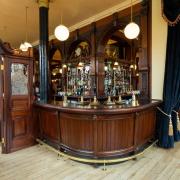 The Boleyn Tavern's main bar complete with wooden screens based on an original which remains and includes a pot man's door through which glass collectors would pass.