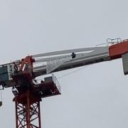 A man who has been on top of a crane in Canning Town since Wednesday morning has vowed to continue his protest.