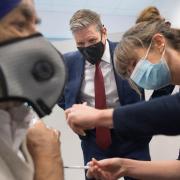 Labour leader Sir Keir Starmer watches as Dr Lizzie Goodman injects a patient with their first dose of the Pfizer-BioNTech Covid-19 vaccine.