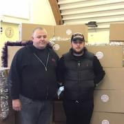 Peter and Mark McCabe from AGS Doors and Shutters with the donation of hampers.