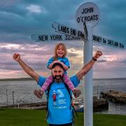 Dave Thomas with daughter Willow at the completion of the walk in John o'Groats