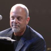 Billy Joel performs on stage at Wembley Arena in 2006