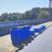 Newham Council is appealing for information after blue barrels were abandoned on a slip road
