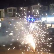 Still from anonymous footage showing fireworks being set off on a busy street