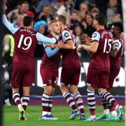 West Ham United players celebrate their first goal against Arsenal