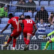 Leyton Orient's Dan Agyei (left) scores from the penalty spot at Reading. Picture: STEVEN PASTON/PA