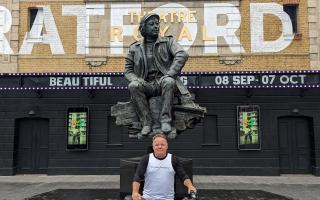 David Nellist outside Theatre Royal with bike in Stratford East